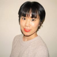 Asian woman with short dark hair and bangs